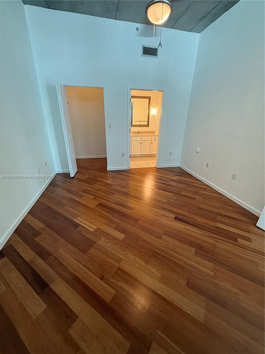 2001 Biscayne Boulevard, Unit 2402 Miami, FL 33137 - Photo 28 of 64 a view of empty room with wooden floor