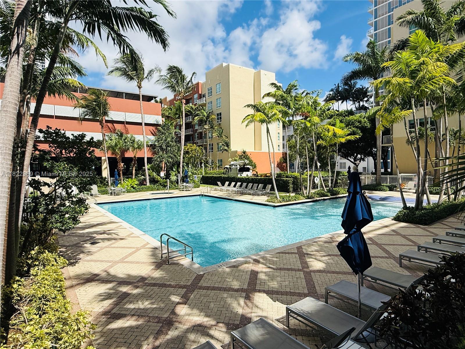 2001 Biscayne Boulevard, Unit 2402 Miami, FL 33137 - Photo 52 of 64 a swimming pool with outdoor seating and yard