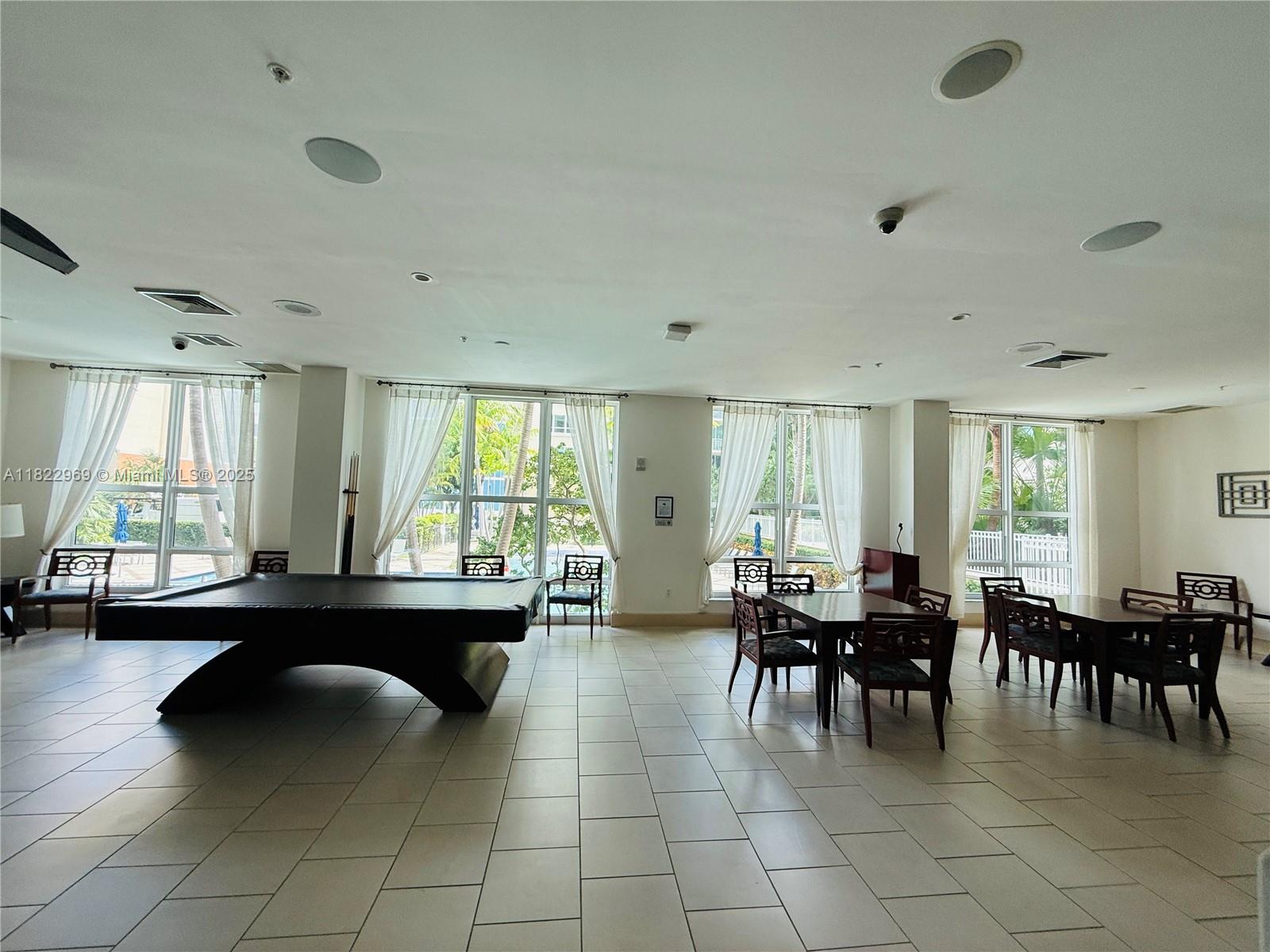 2001 Biscayne Boulevard, Unit 2402 Miami, FL 33137 - Photo 59 of 64 a view of a dining room with furniture and chandelier
