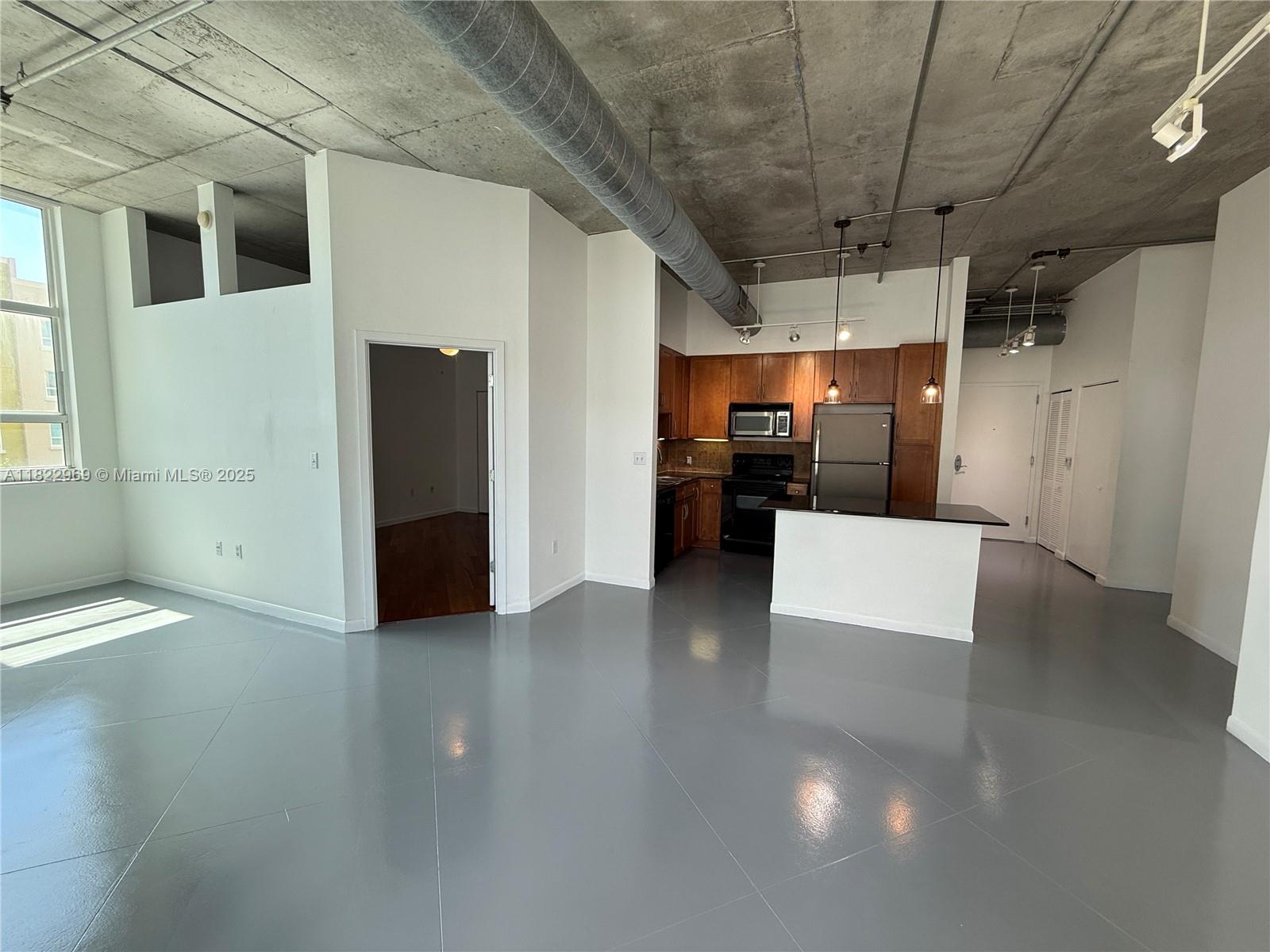 2001 Biscayne Boulevard, Unit 2402 Miami, FL 33137 - Photo 6 of 64 a view of a refrigerator in kitchen and empty room
