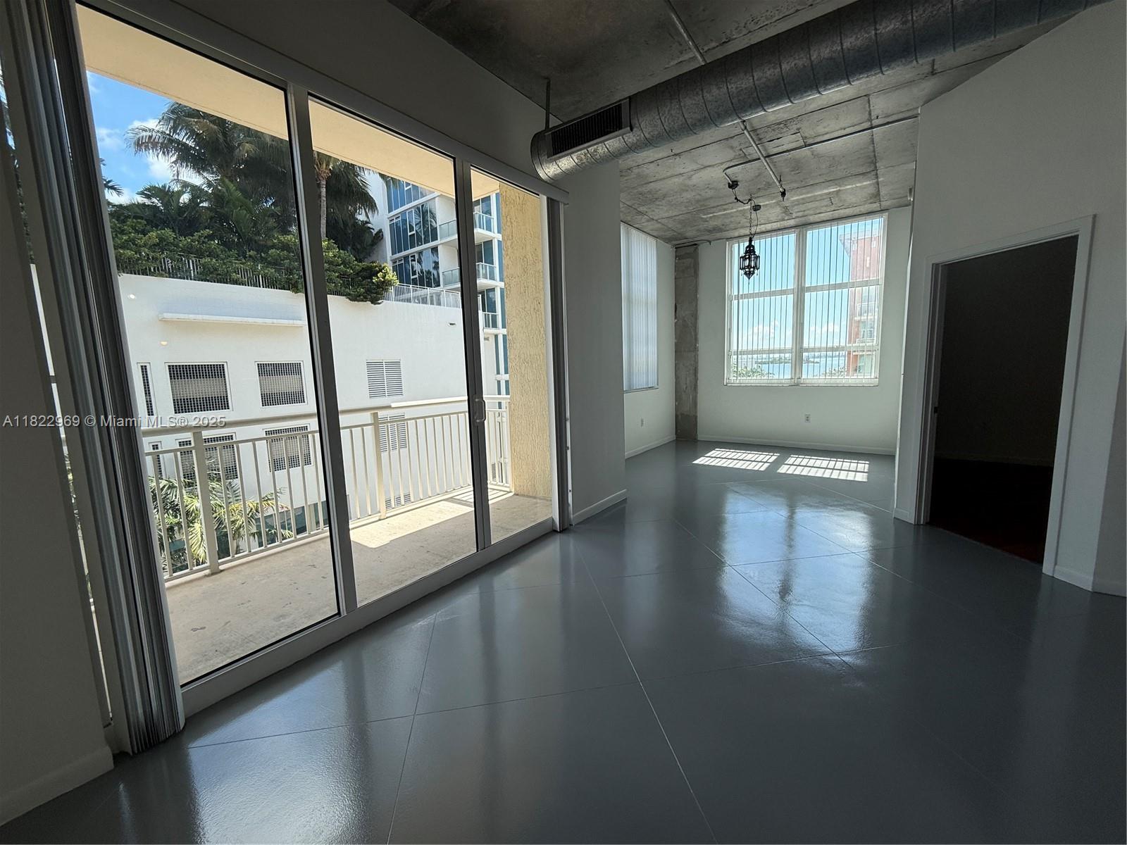 2001 Biscayne Boulevard, Unit 2402 Miami, FL 33137 - Photo 8 of 64 a view of empty room with wooden floor and fan