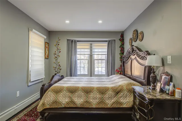 a bed sitting in a spacious bedroom next to a window