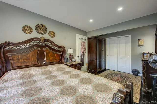 a bedroom with a bed and a dresser in it