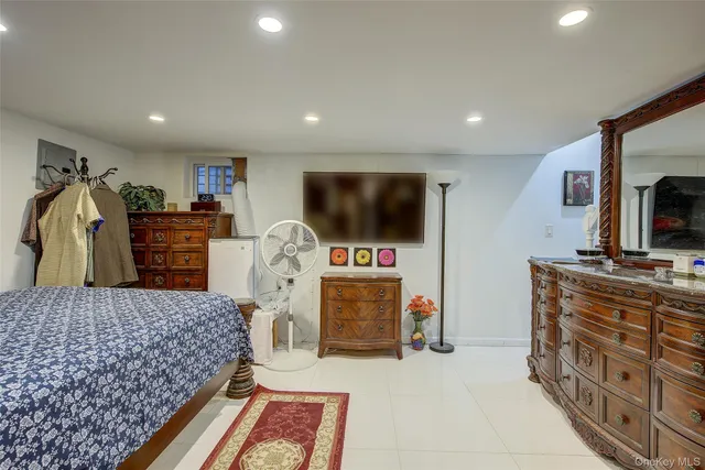 a bedroom with furniture and a flat screen tv