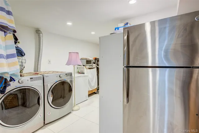 a view of a storage & utility room with dryer and washer