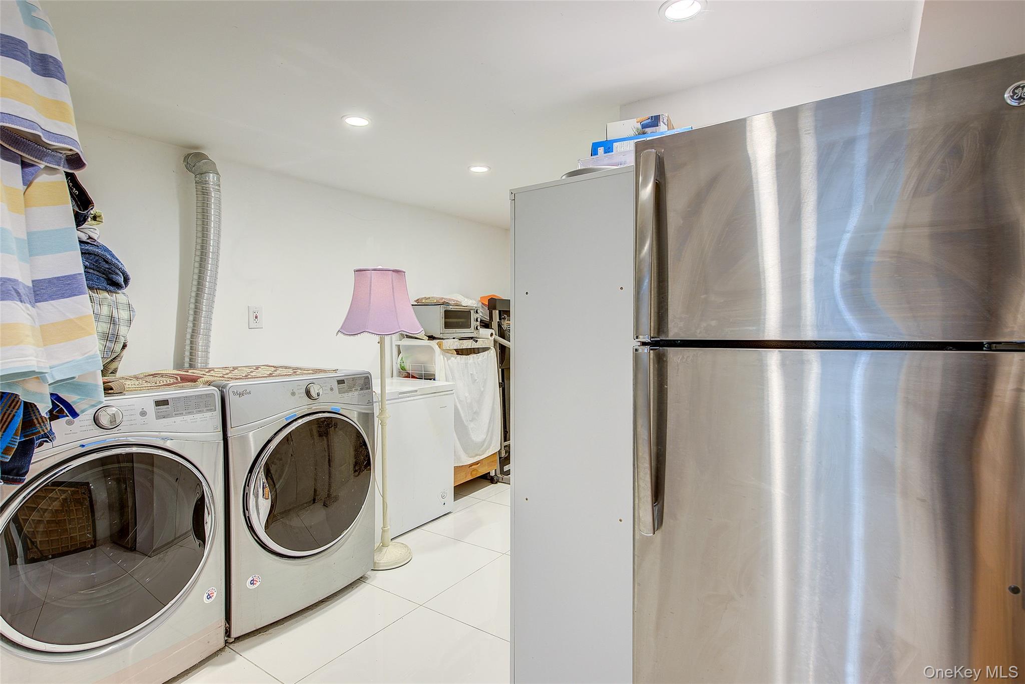 89-06 175th Street Queens, NY 11432 - Photo 23 of 29 Washroom featuring light tile patterned floors, recessed lighting, and washing machine and dryer