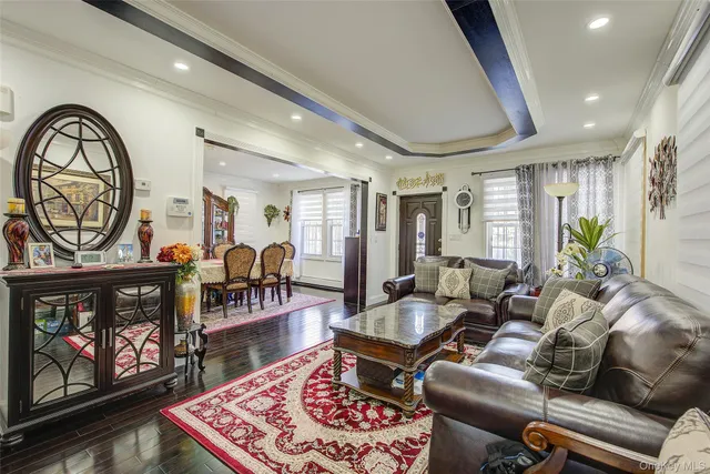 a living room with furniture a fireplace and a floor to ceiling window