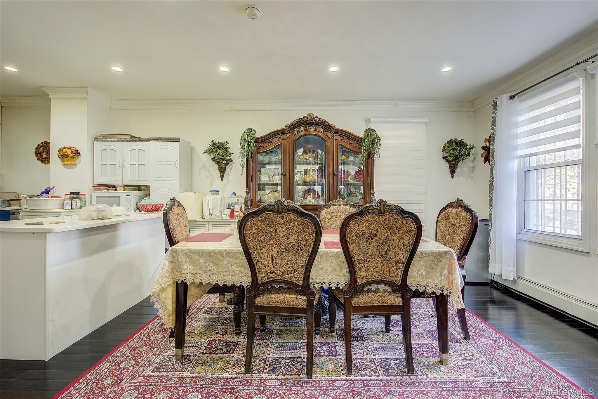 89-06 175th Street Queens, NY 11432 - Photo 7 of 29 Dining area featuring crown molding, dark wood-style flooring, and recessed lighting