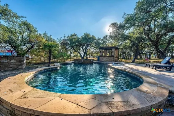 a view of a swimming pool with an outdoor seating