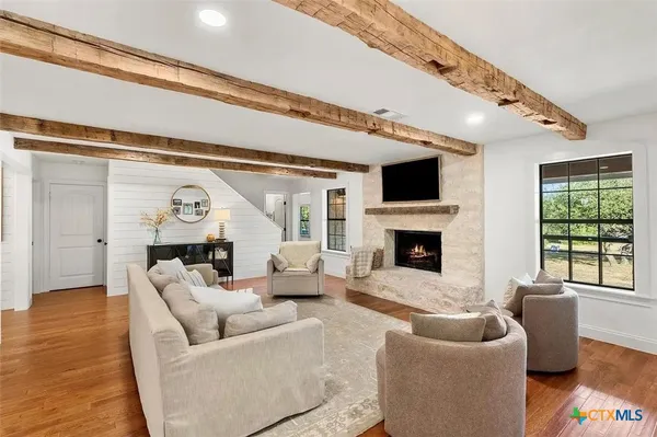 a living room with furniture flat screen tv and a fireplace