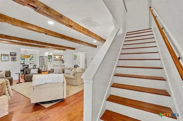 a living room with furniture and stairs