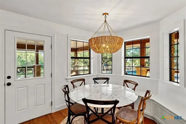 a view of a dining room with furniture window and wooden floor