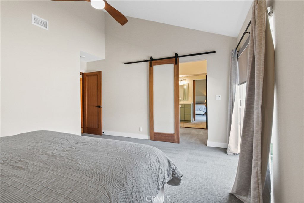 34561 Calle Monte Dana Point, CA 92624 - Photo 11 of 22 a bedroom with a bed and a large mirror