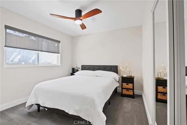 a bedroom with a bed and a large window