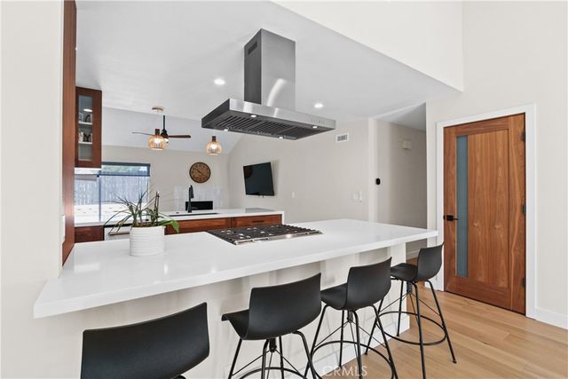 a view of a kitchen with a table and chairs