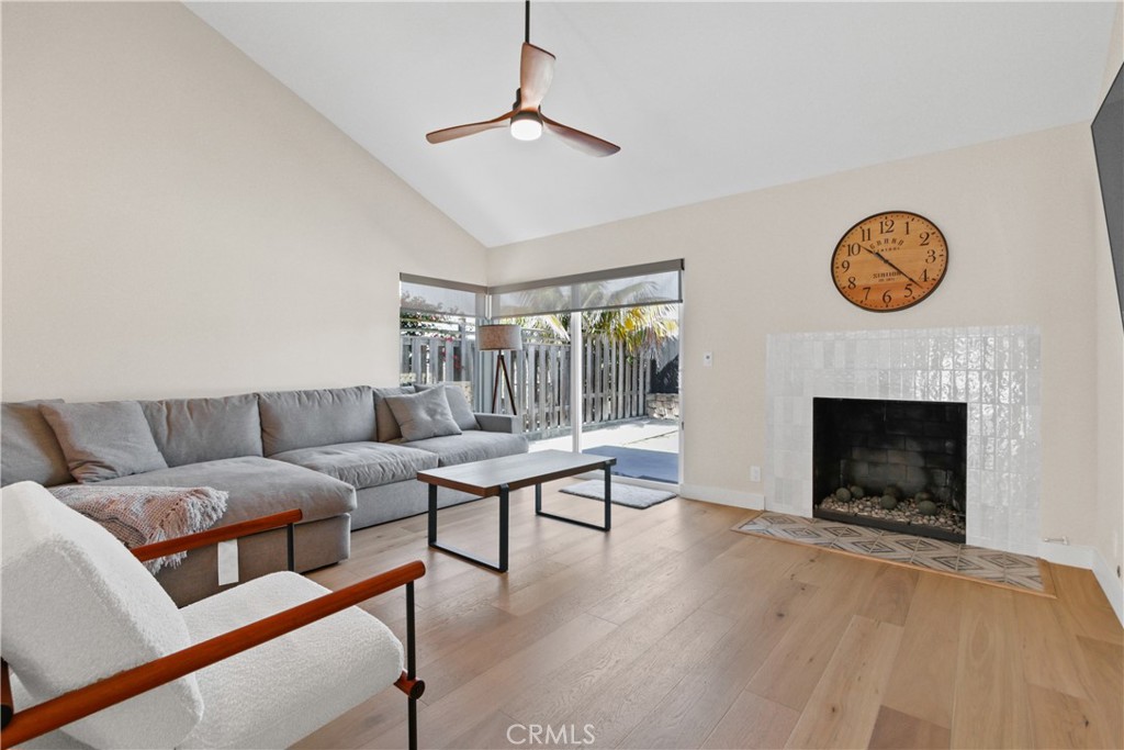 34561 Calle Monte Dana Point, CA 92624 - Photo 8 of 22 a living room with furniture a clock and a fireplace