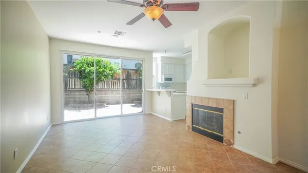 a view of a livingroom with a fireplace and window