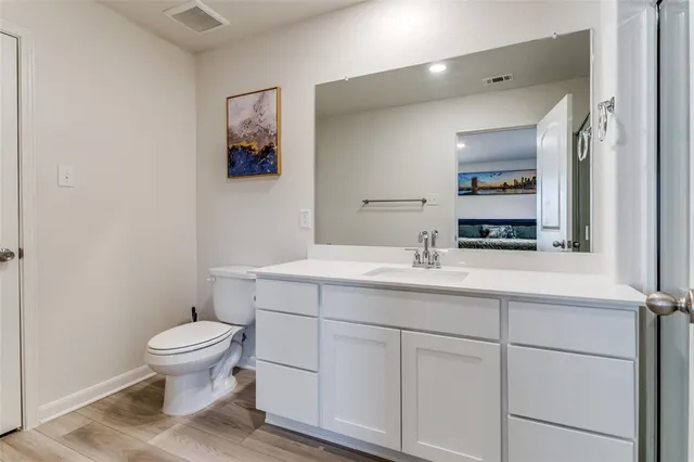 a bathroom with a toilet a sink and mirror
