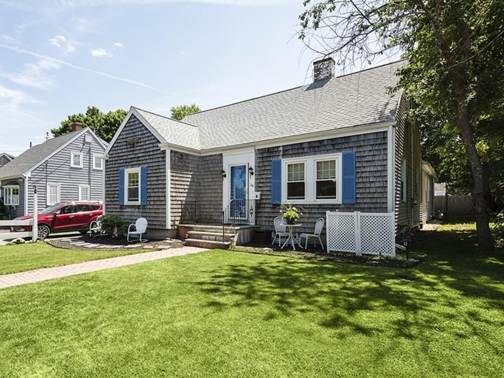 a front view of house with yard and outdoor seating