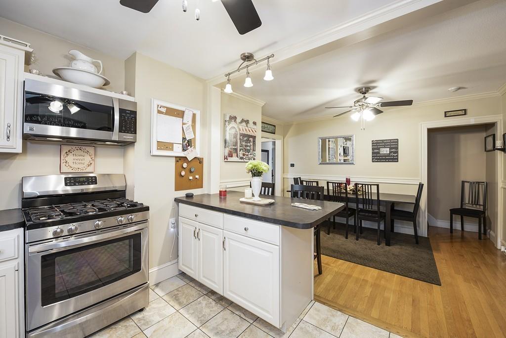 26 Elsworth Road Newton, MA 02465 - Photo 7 of 18 a kitchen with stainless steel appliances a stove a sink and a refrigerator