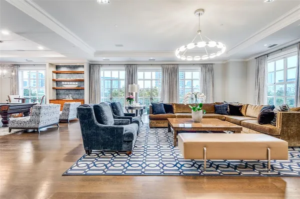 a living room with fireplace furniture and a chandelier