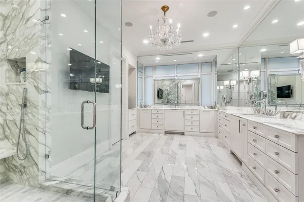 a large bathroom with a large mirror vanity and shower
