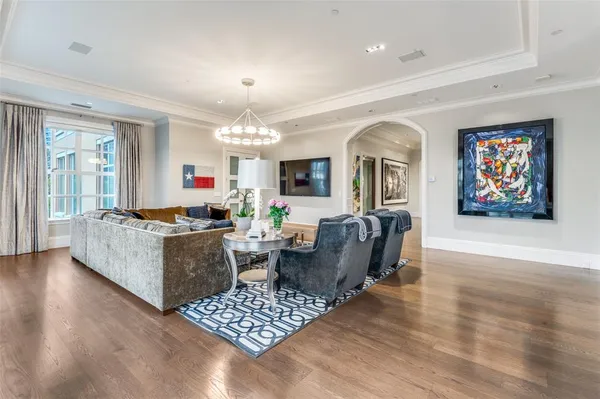 a living room with furniture a dining table and a fireplace