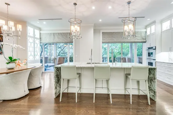 a dining table chairs window and wooden floor