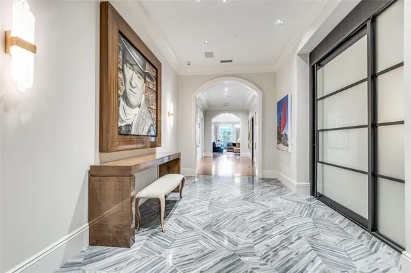 a view of a hallway with wooden floor and furniture