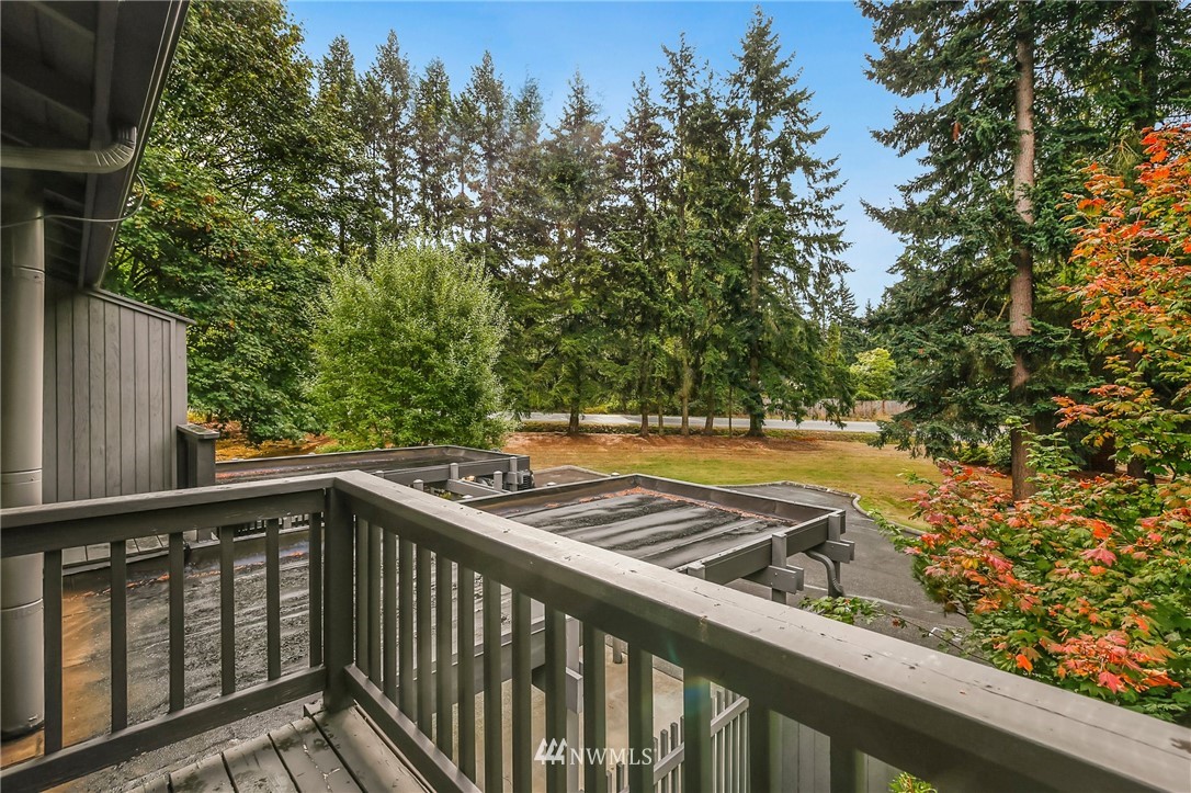 2008 Southeast 16th Court Renton, WA 98055 - Photo 22 of 34 a view of balcony with wooden floor and trees in the background
