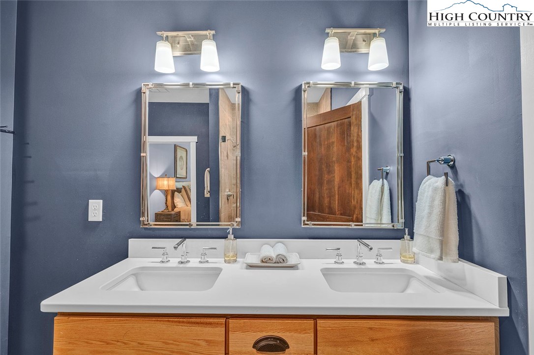 188 Ramblestone Terrace, Unit 101 Boone, NC 28607 - Photo 29 of 48 a bathroom with double vanity sinks and a mirror