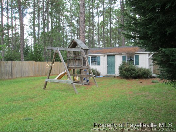 702 Wildwood Road Aberdeen, NC 28315 - Photo 19 of 19 a view of a house with backyard and a slide