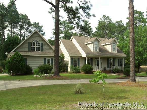 702 Wildwood Road Aberdeen, NC 28315 - Photo 2 of 19 a front view of a house with garden