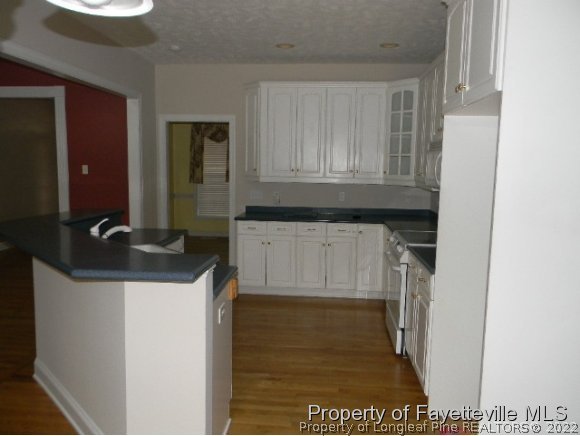 702 Wildwood Road Aberdeen, NC 28315 - Photo 5 of 19 a kitchen with a sink and cabinets