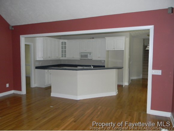 702 Wildwood Road Aberdeen, NC 28315 - Photo 8 of 19 a kitchen with a sink cabinets and wooden floor