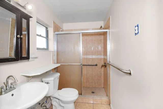 a bathroom with a sink toilet and shower