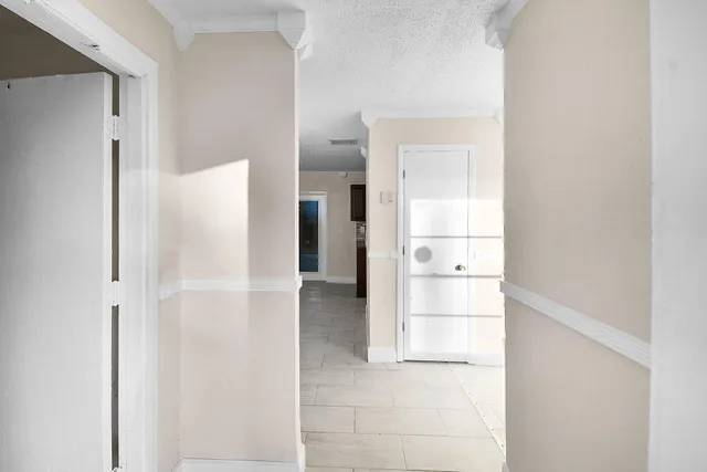 a view of a kitchen with a refrigerator and a sink