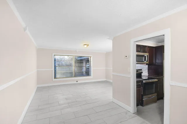 a view of kitchen with windows and refrigerator