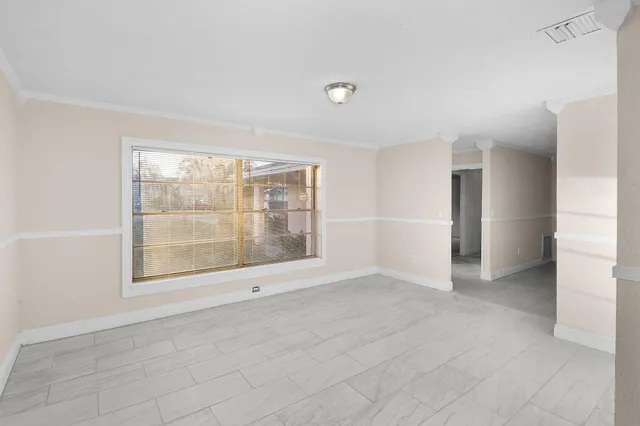 an empty room with windows and closet