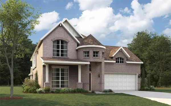 a front view of a house with a garden and yard