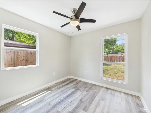 a view of room with window and ceiling fan