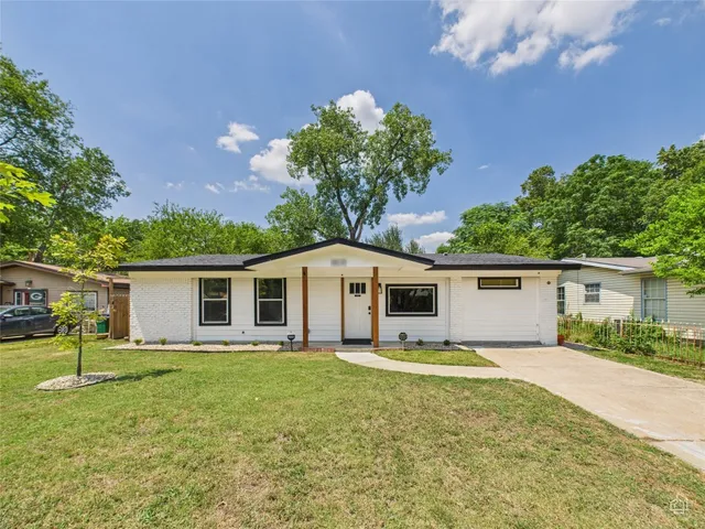a front view of house with yard and green space