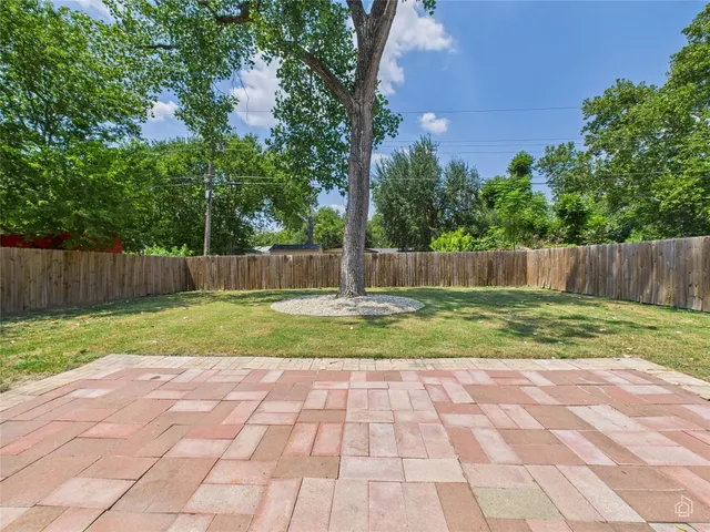 a view of garden with tall trees