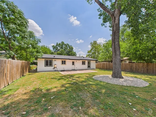 a house with sign broad in front of it