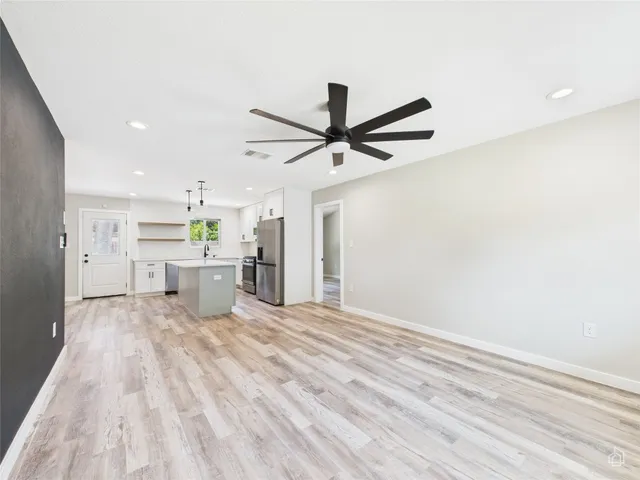 a view of a kitchen with sink stainless steel appliances and cabinets