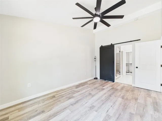 a view of a room with a ceiling fan