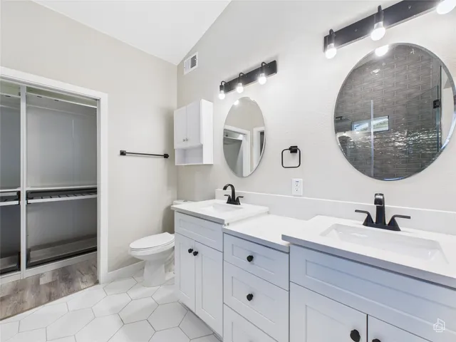 a bathroom with a toilet sink and mirror