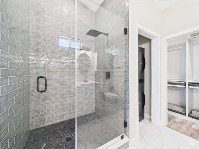 a bathroom with a glass shower door