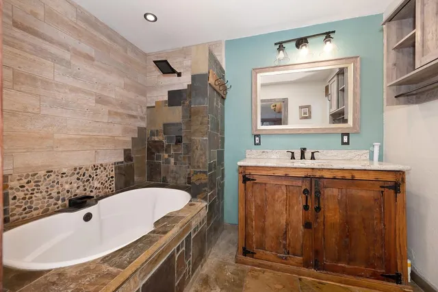 a kitchen with stainless steel appliances granite countertop a refrigerator and a stove top oven