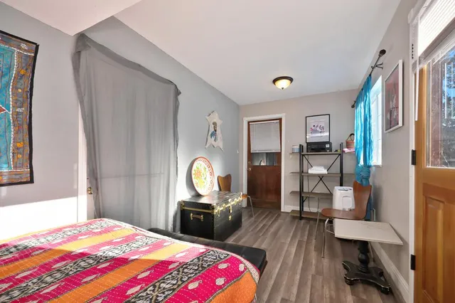 a view of two chairs and table in the patio